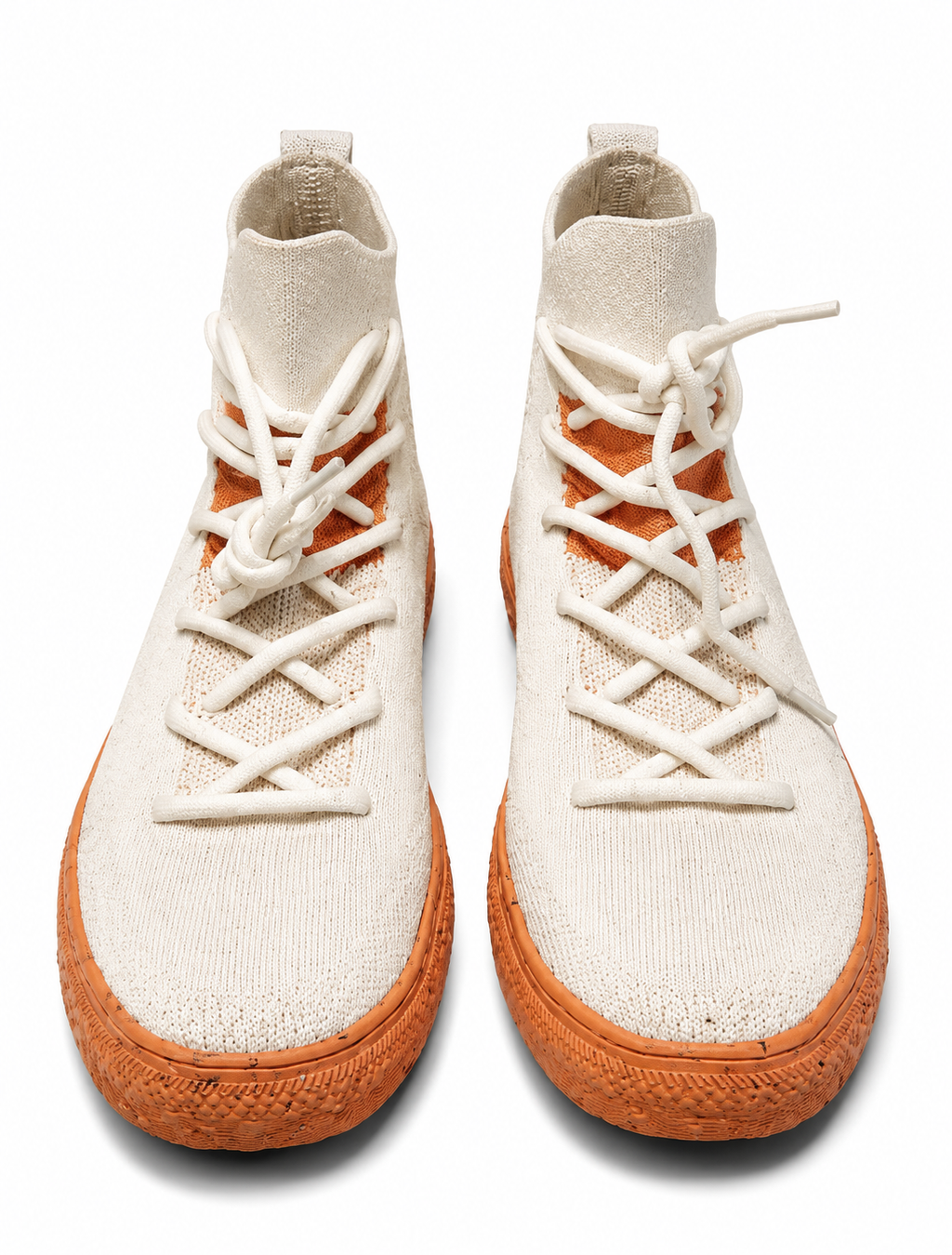 Pair of white high-top sneakers with brown soles on a white background