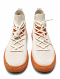 Pair of white high-top sneakers with brown soles on a white background