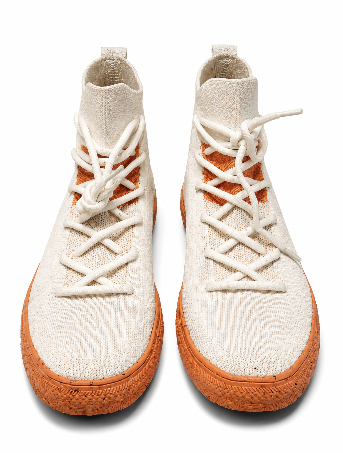 Pair of white high-top sneakers with brown soles on a white background