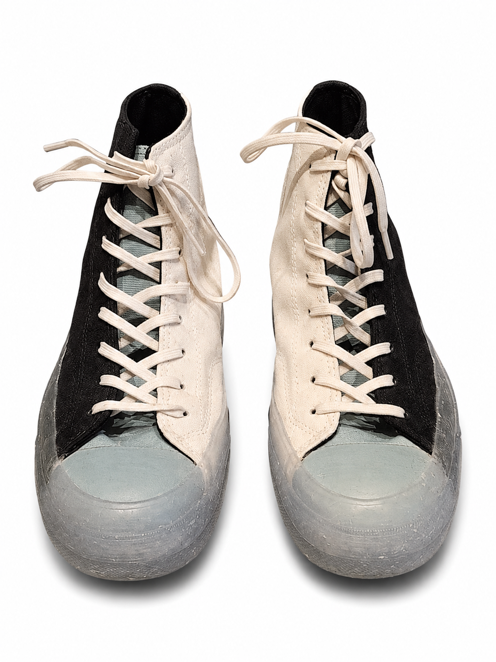 Pair of high-top sneakers with black and white design on a white background