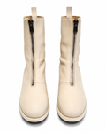 Pair of cream-colored boots with zippers on a white background