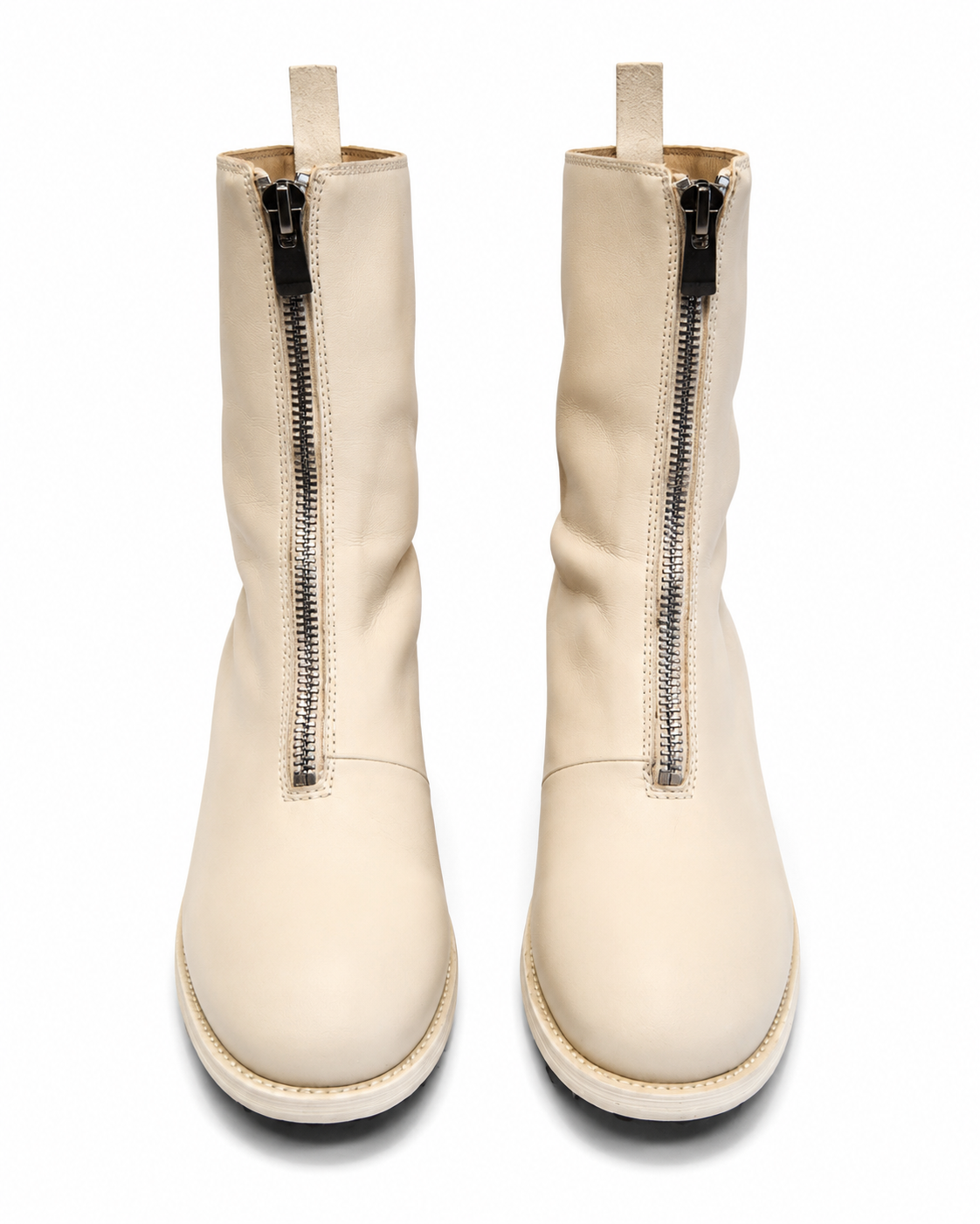 Pair of cream-colored boots with zippers on a white background