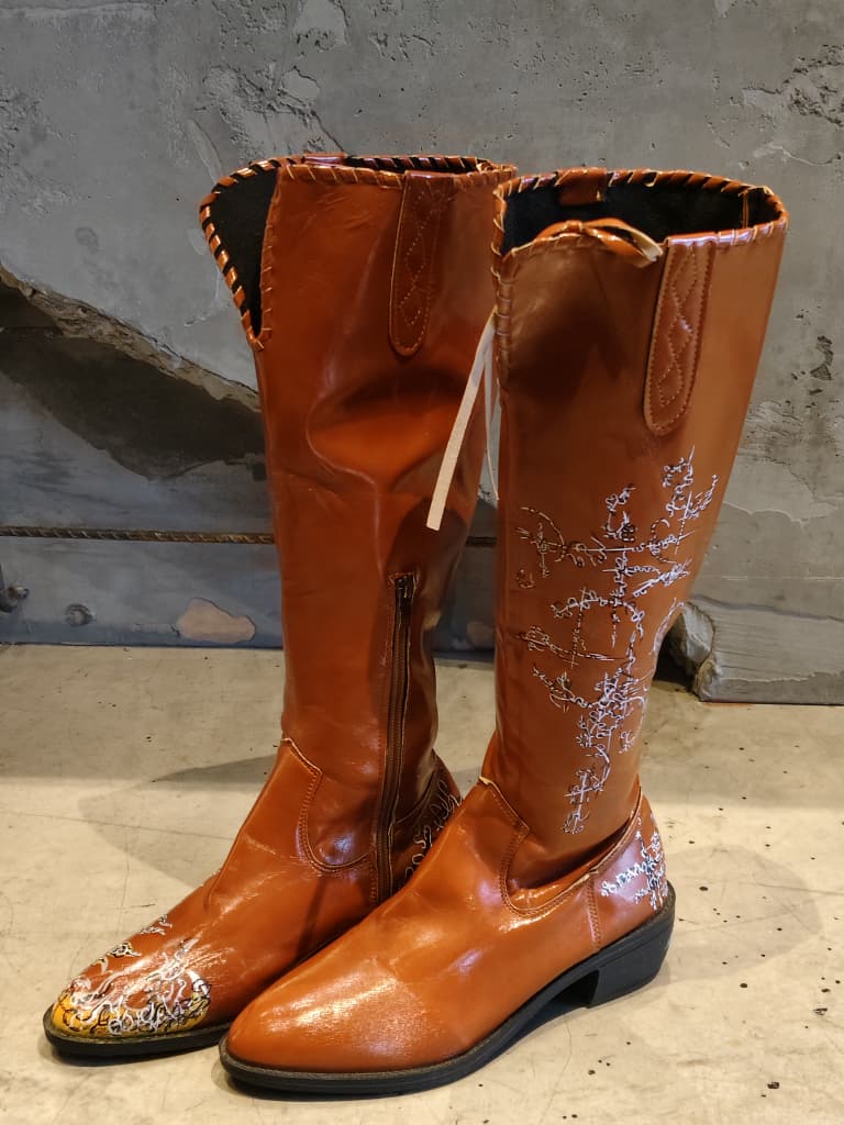 Front view of shoes in vegan leather cowboy boots showing the sole unit and upper silhouette