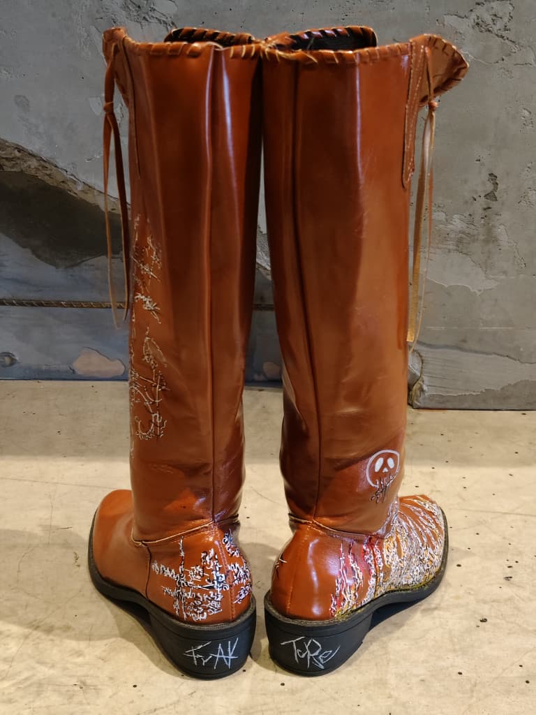 Front view of shoes in vegan leather cowboy boots showing the sole unit and upper silhouette