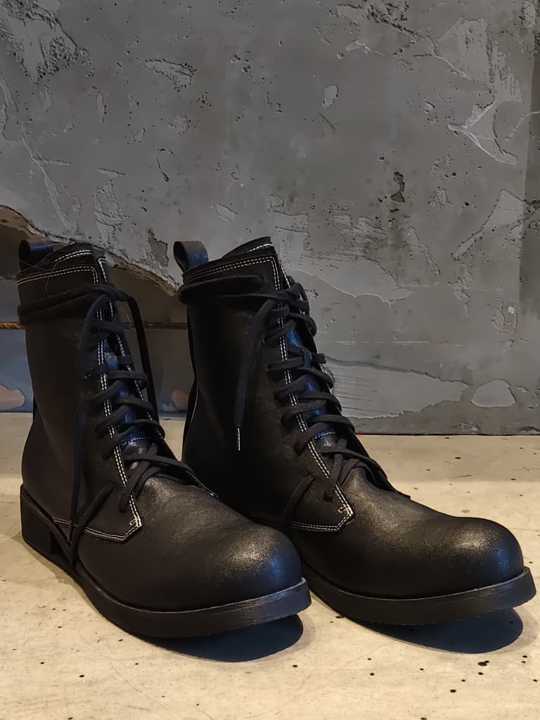 Front view of shoes in vegan leather showing the sole unit and upper silhouette