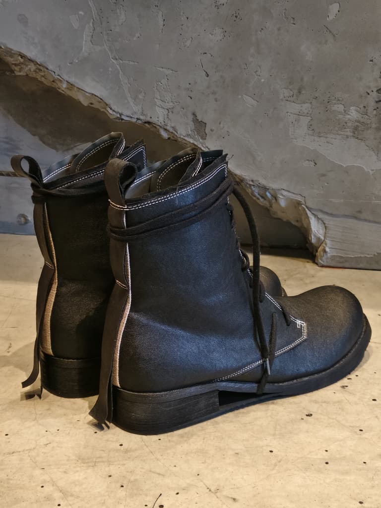 Front view of shoes in vegan leather showing the sole unit and upper silhouette