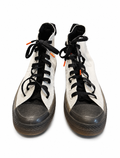 Pair of high-top sneakers with black laces and white canvas on a white background