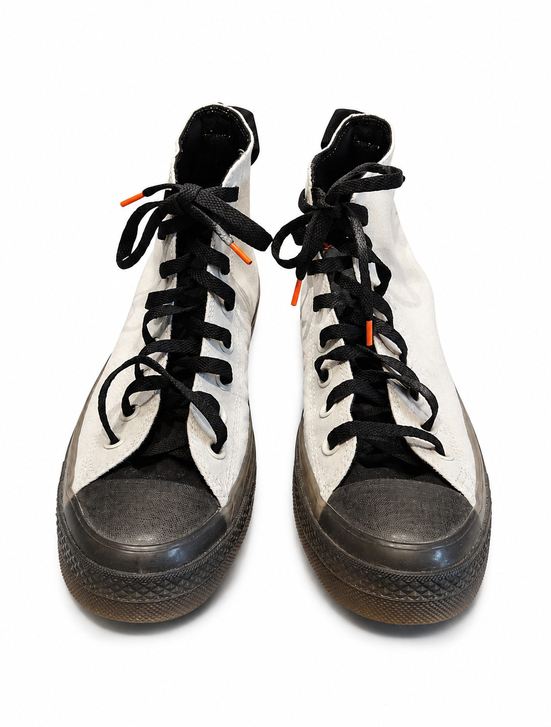Pair of high-top sneakers with black laces and white canvas on a white background