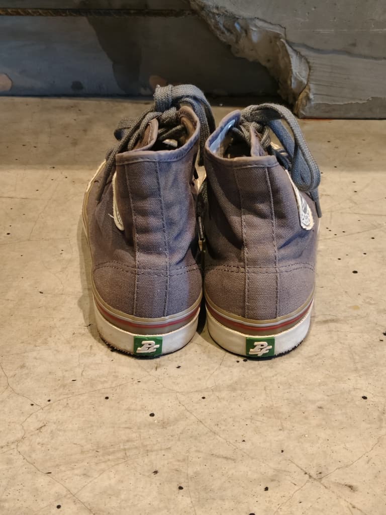 Front view of shoes in grey canvas showing the sole unit and upper silhouette