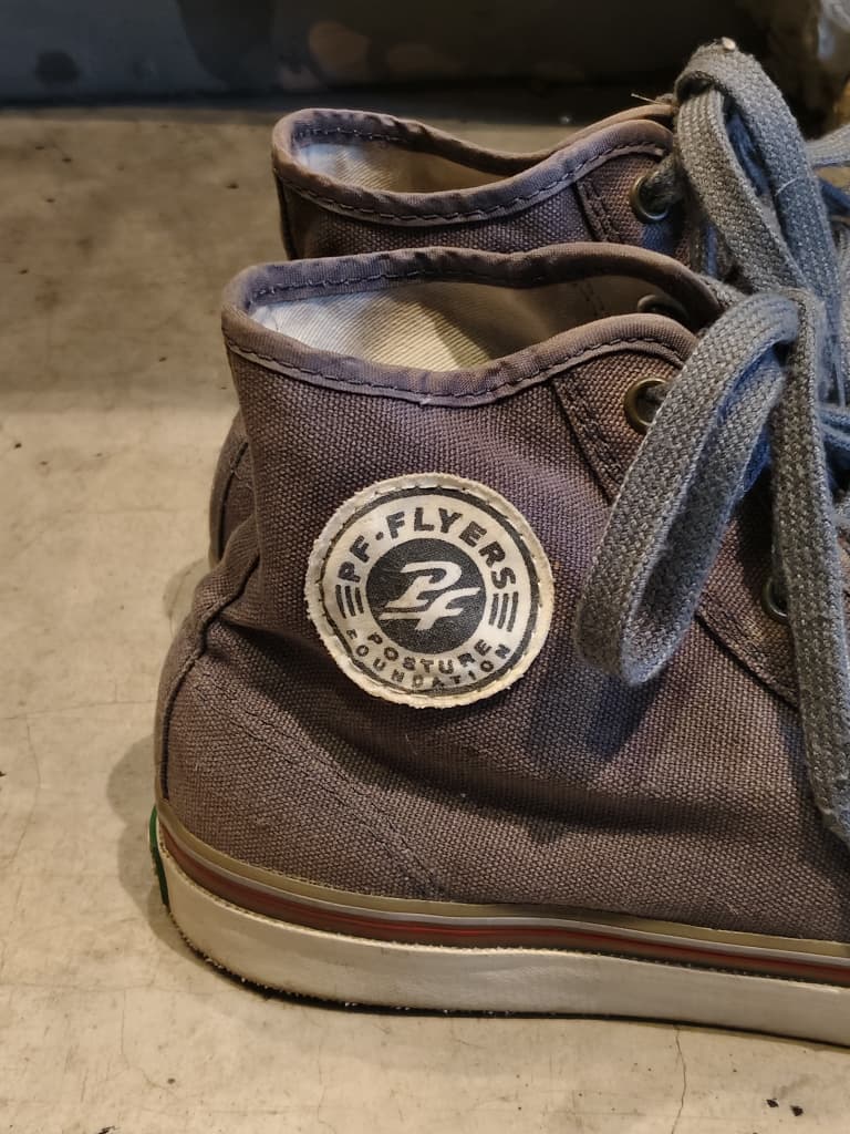 Front view of shoes in grey canvas showing the sole unit and upper silhouette