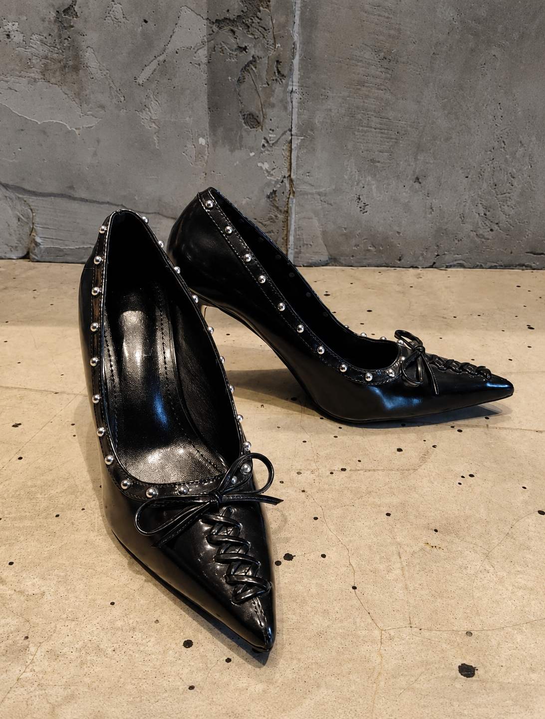Black Studded Leather Pointed-Toe Pumps with Bow