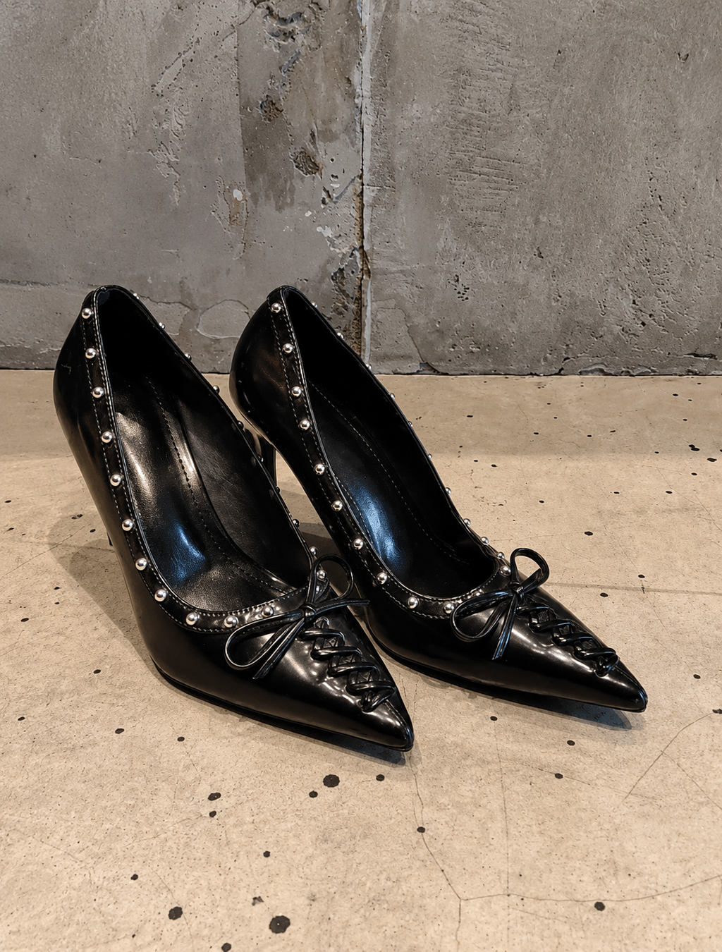 Black Studded Leather Pointed-Toe Pumps with Bow