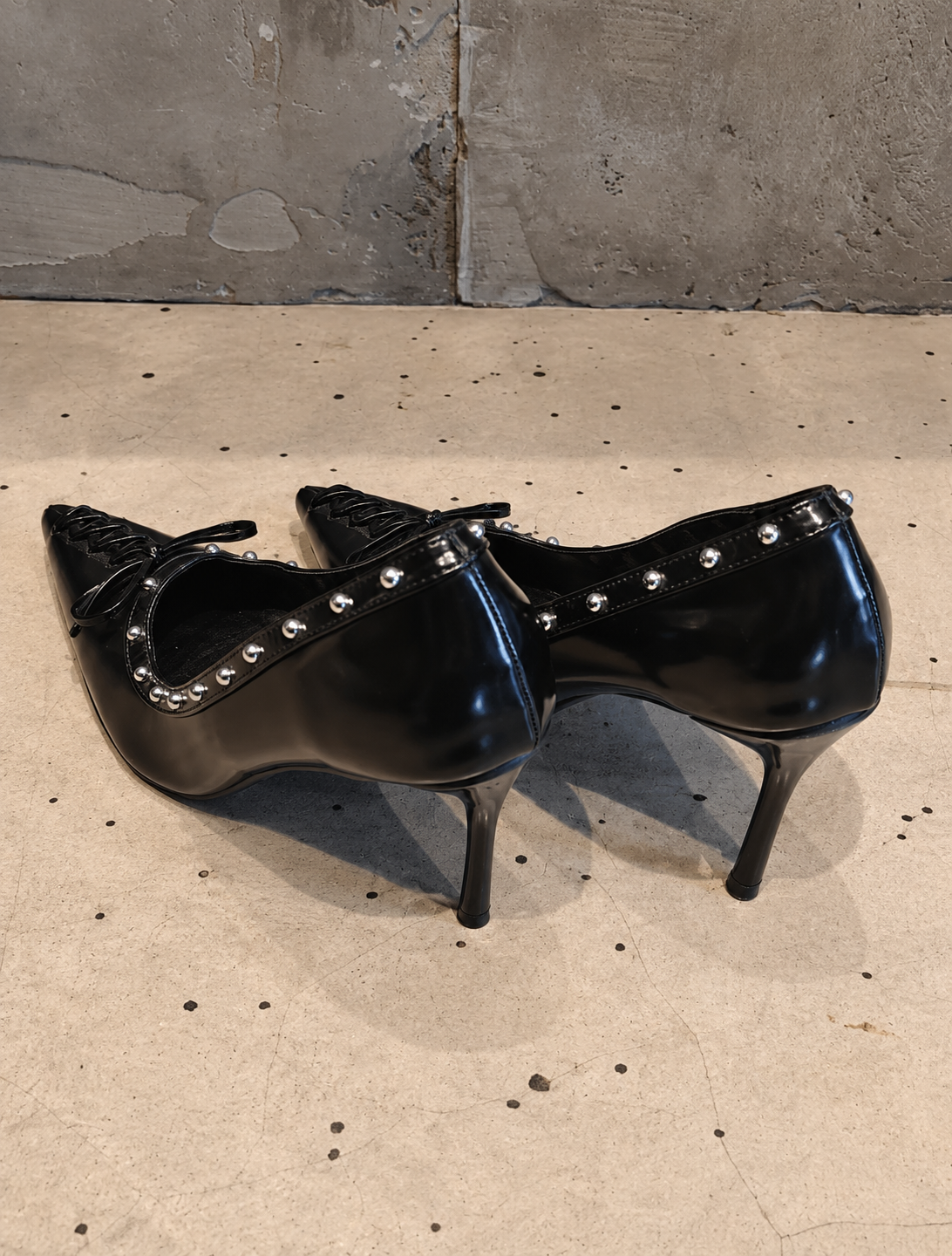 Black Studded Leather Pointed-Toe Pumps with Bow