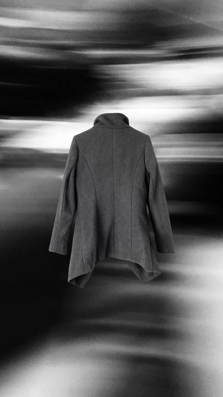 Dark wool coat with diagonal zip detail and architectural cut