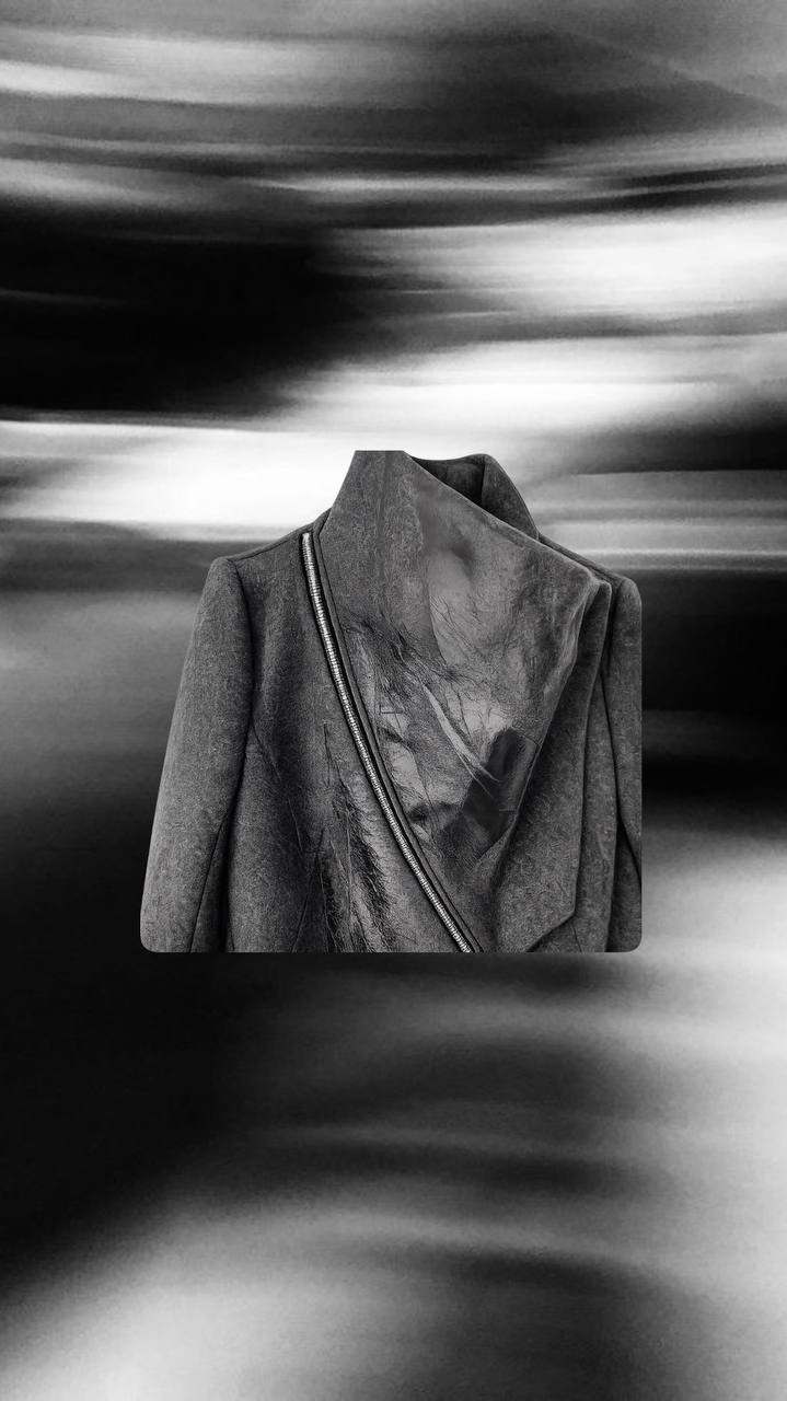 Dark wool coat with diagonal zip detail and architectural cut